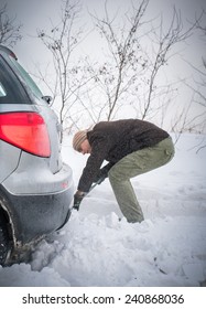 Man Digging Up Stuck In Snow Car