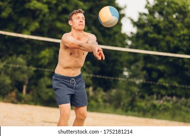 Man digs at beach volleyball