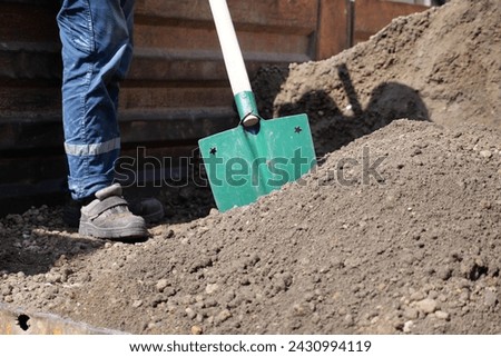 a man digs his spring garden with an old shovel.