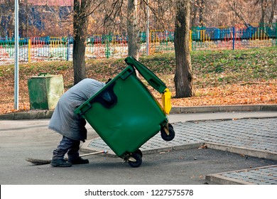 Man Digs In The Trash. Homeless And Jobless Person