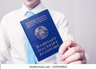 Man Or Diplomat Shows A Passport Of A Citizen Of The Republic Of Belarus, A Man Offers Citizenship Of The Republic Of Belarus, Male Hands, Close-up, Cropped Image, Toned