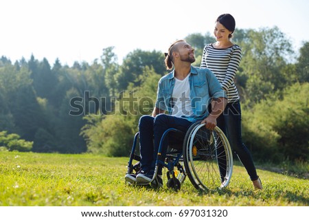 Man with disabilities and his wife exchanging loving looks