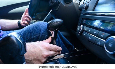 A Man With A Disability Drives A Car. Hand Controls For Braking And Acceleration In Car. Car Adaptations For Disabled Drivers.