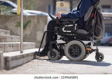 Man With Disability On Wheelchair Stopped In Front Of Staircase, Raising Awareness Of Architectural Barriers And Accessibility Issues