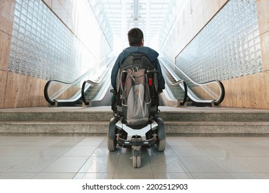 Man With Disability On Wheelchair Stopped In Front Of Staircase, Raising Awareness Of Architectural Barriers And Accessibility Issues