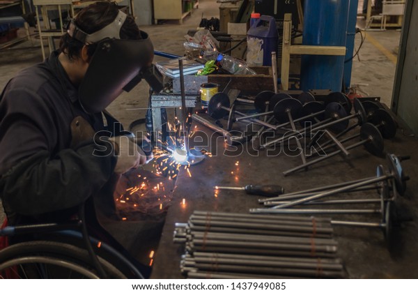 Man Disabled leg Wheelchair Steel\
welding in a factory industry Car Get a chance Can\
work