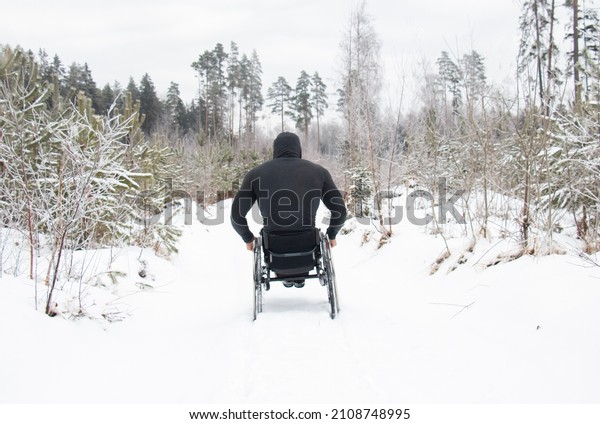 man disabled wheelchair user, spinal\
injury, human wheelchair winter difficulty\
movement