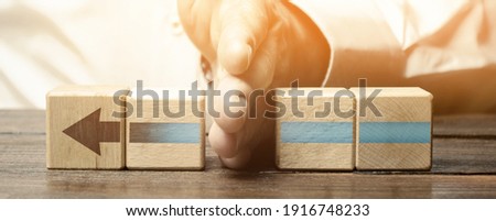 Man divides the arrow blocks into two parts. Interruption of the process, decreased activity. Stop financing and supply, slowing down progress. Incompetence and sabotage. Career end. poor performance