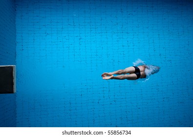 man diving into blue pool water - Powered by Shutterstock