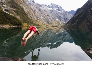 Man Diving Into Lake Marian, In Fiordland National Park, Aotearoa