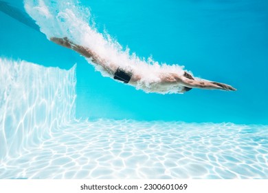 Man diving into swimming pool
