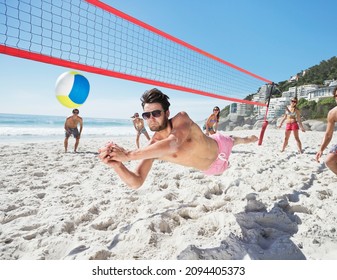 Man diving for volleyball on beach - Powered by Shutterstock