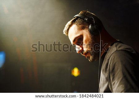 Man DJ performace at summer festival, close up shot.