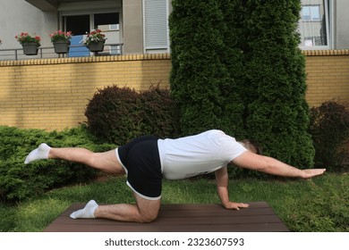 Man do back exercises for lower back Quadruped arm, leg raise