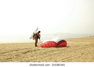 Man Do Some Fold Parachute Arter Landing His Paramotor In Beace