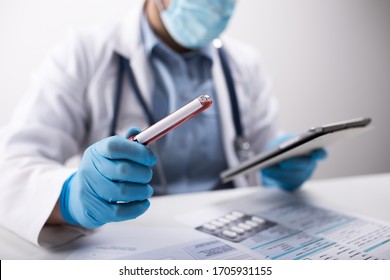 Man Doctor With Blood Test Tube In Hands