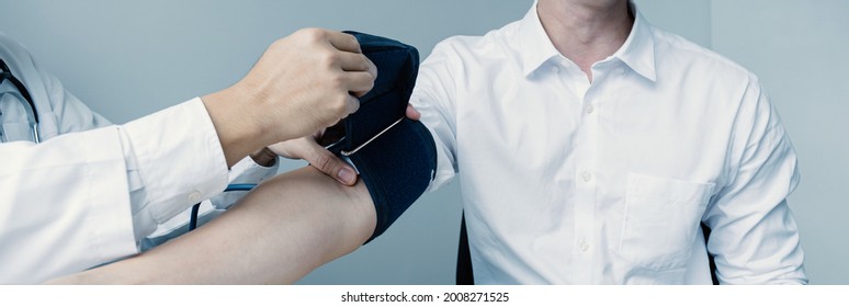 The man doctor hand use the pulse meter to measure the pressure of the patient, medical checkup concept. - Shutterstock ID 2008271525