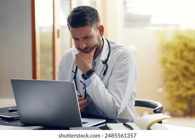 Man, doctor and laptop with research, ideas and thinking in office as medical professional. Male person, pediatrician and diagnosis, telehealth and technology for patient records, medicine or surgery - Powered by Shutterstock