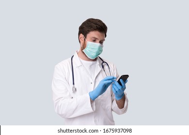 Man Doctor Wearing Medical Mask Using Phone. Virus Concept. Medical Worker