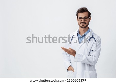 Man doctor in white coat and eyeglasses smile shows hand gestures signs on white isolated background looks into camera, copy space, space for text, health