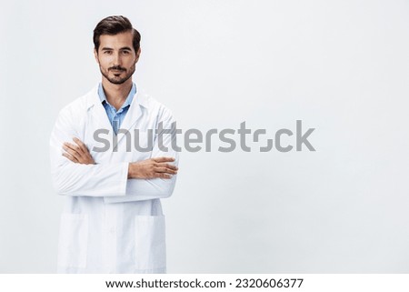 Man doctor in white coat looking into camera on white isolated background, copy space, space for text, health