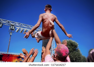 A Man Does Crowd Surfing During A Concert.