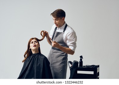 A Man Does A Haircut To A Woman With Red Hair                    