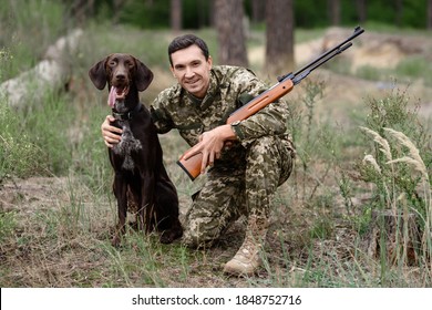 A Man With A Dog On A Hunt Looking For Prey. A Dog Stands Next To The Hunter And Waits For The FAS Team.