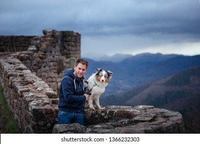 Man And Dog Travel Together. Pet And His Friend In Nature. Australian Shepherd And Its Owner