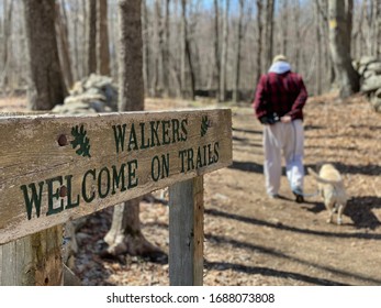 Man and dog walking at Weir National Park in Wilton Connecticut