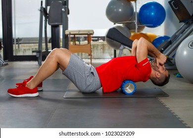 Man doing auto mobilization technique with foam roller for increasing spine mobility 