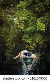 A Man Doing Back Flip With Water Splash.