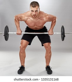 Man Doing Back Workout, Barbell Row In Studio Over Gray Background