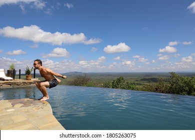 Man Doing Backflip Into Pool In Africa