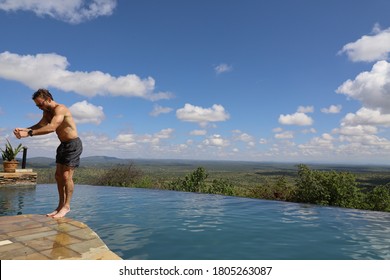 Man Doing Backflip Into Pool In Africa