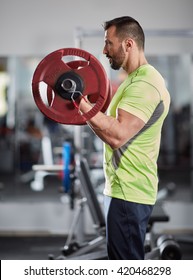 Man Doing Barbell Biceps Curl In The Gym