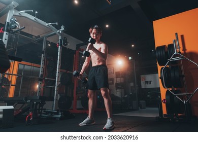 Man Doing Bicep Curls In The Gym