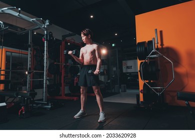 Man Doing Bicep Curls In The Gym