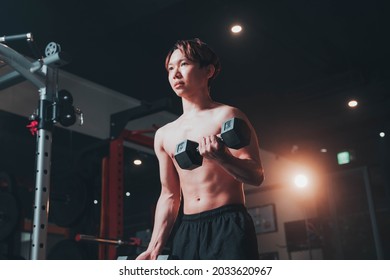 Man Doing Bicep Curls In The Gym