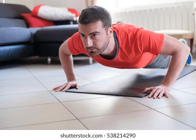 Man Doing Body Exercise And Working Out At Home