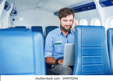 Man doing business in the airplane - Powered by Shutterstock