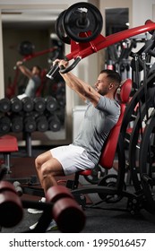 Man Doing Chest Workout In The Gym At The Machine