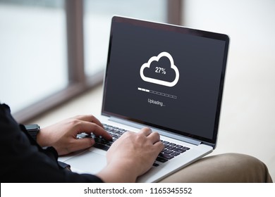Man doing cloud uploading on laptop / computer at office