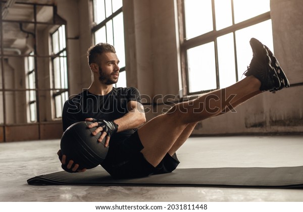 Man doing core\
exercise with medicine ball