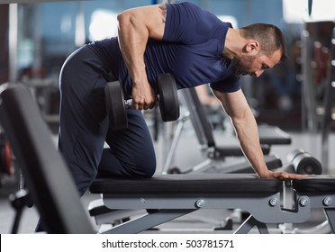 Man Doing Dumbbell Row For Back Workout In The Gym