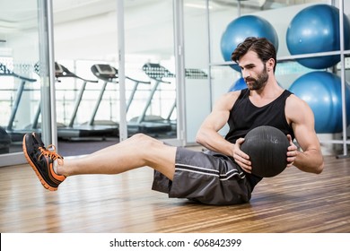 Man Doing Exercise With Medicine Ball In The Studio