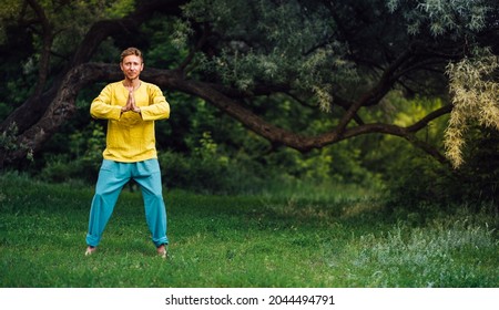 Man doing exercises on the tendon complex. Qigong practice in the nature.