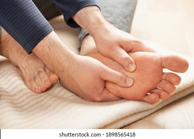 man doing flatfoot correction self massage at home