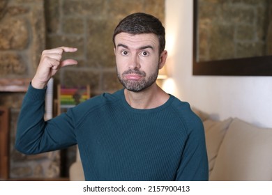 Man doing hand gesture that shows small size