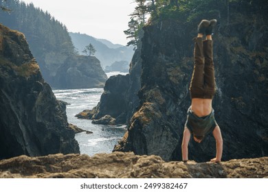 man doing handstand at coast